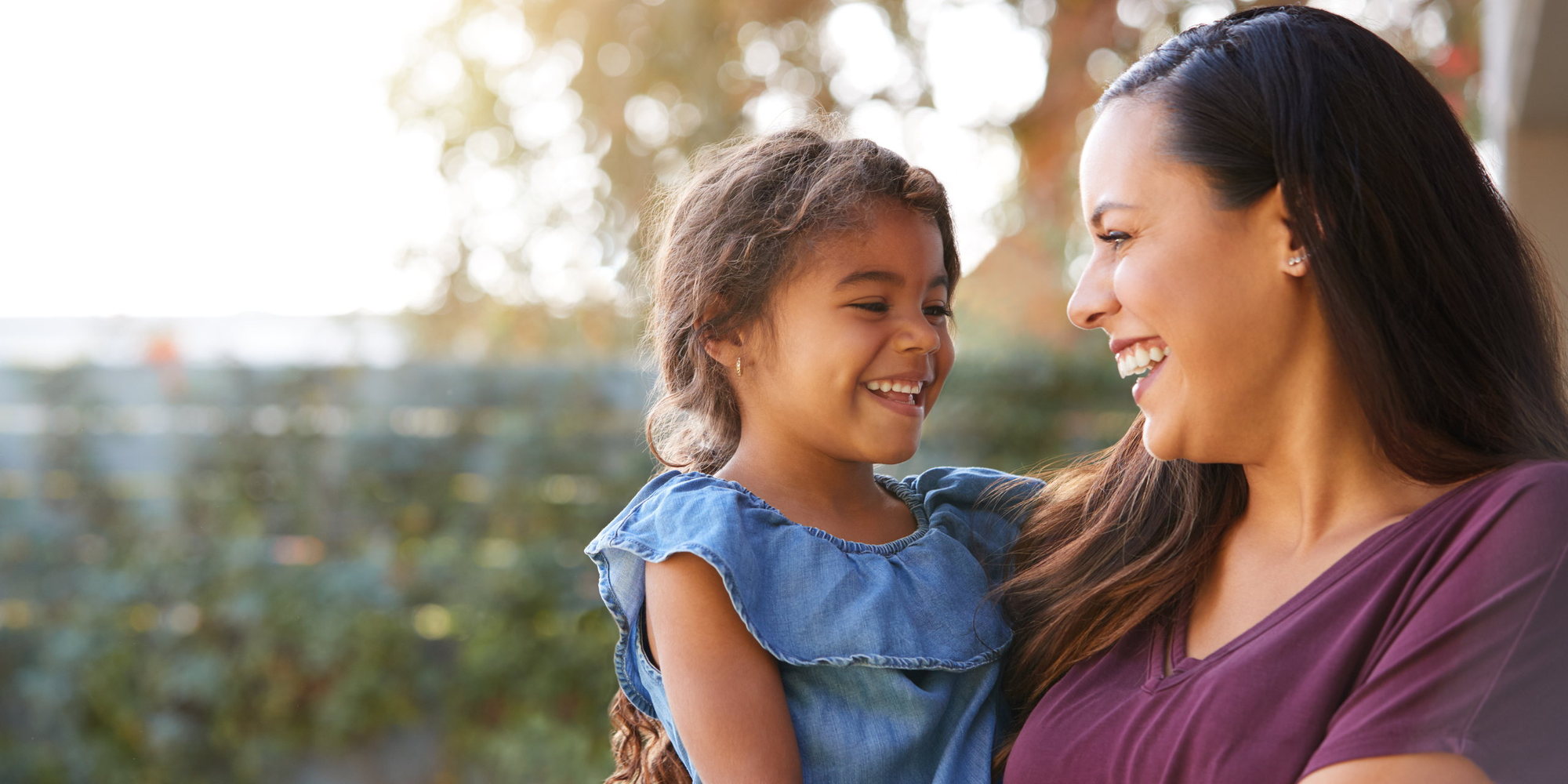 A mother and her daughter laughing together